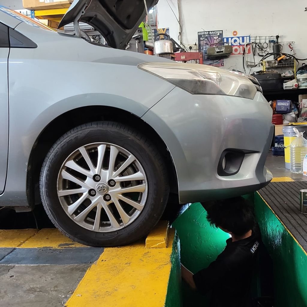 Mechanic inspecting vehicle suspension